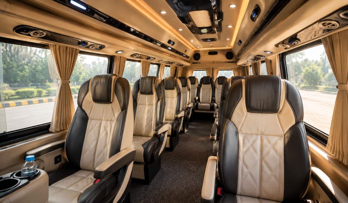 Luxury Tempo Traveller interior featuring premium pushback seats, spacious cabin, air conditioning vents, curtains and comfortable seating for group travel in India.